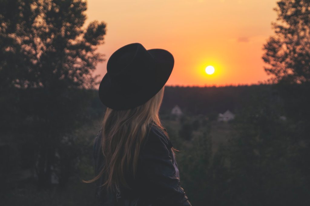 femme qui regarde un coucher de soleil habiller en bohème